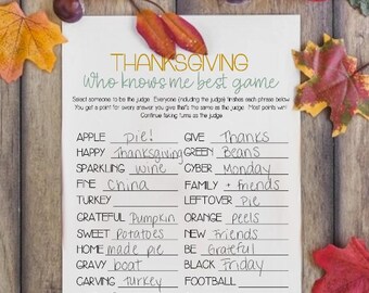 May include: Thanksgiving-themed game with colorful gourds, apples, and fall leaves. A white paper with the text "Thanksgiving Who Knows Me Best Game" is in the center, with fill-in-the-blank phrases.