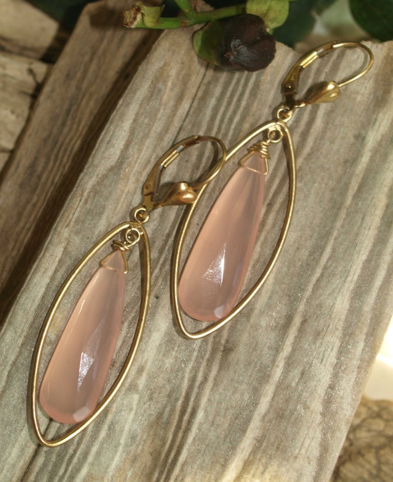 pendulum shaped pink chalcedony bead wire wrapped to loop inside almond shaped gold-filled drop attached to leverback closure Facet cut