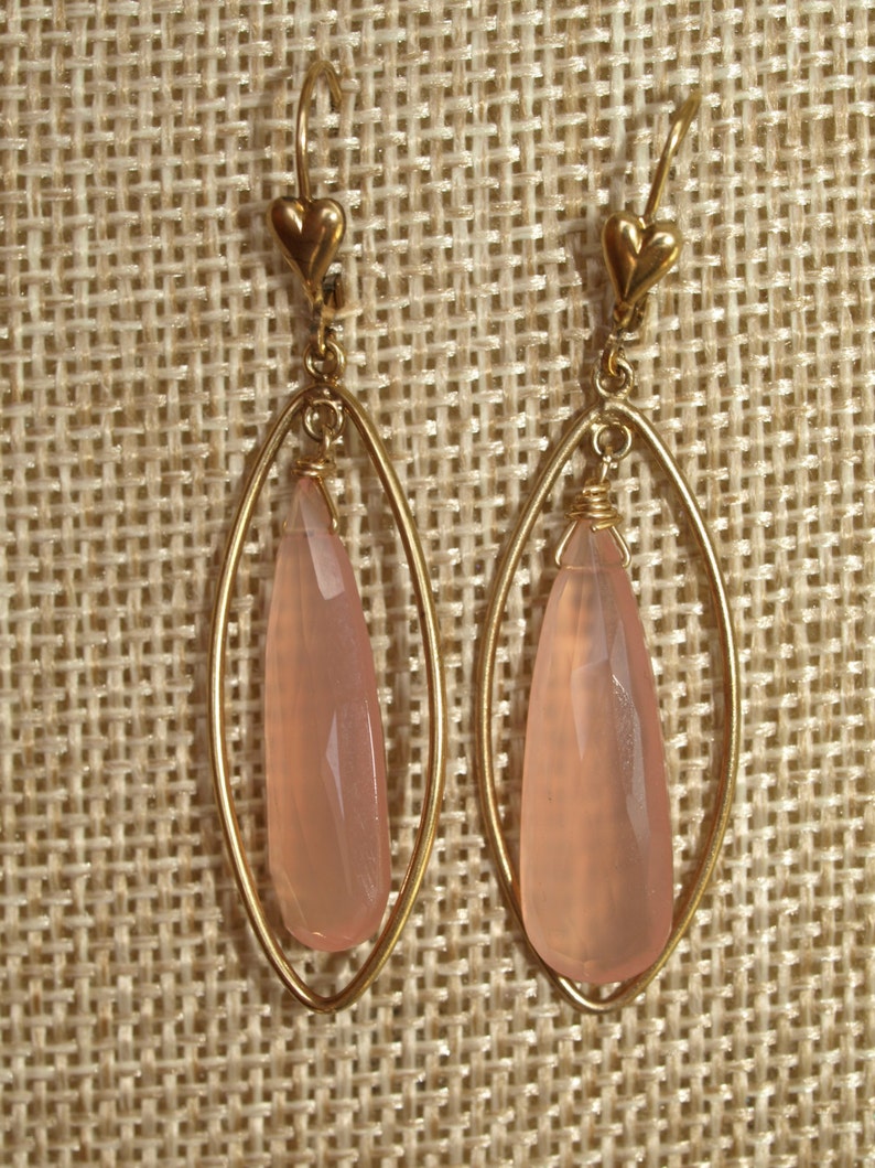 pendulum shaped pink chalcedony bead wire wrapped to loop inside almond shaped gold-filled drop attached to leverback closure Facet cut