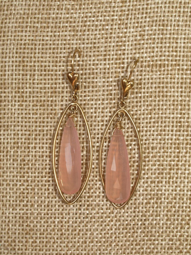 pendulum shaped pink chalcedony bead wire wrapped to loop inside almond shaped gold-filled drop attached to leverback closure Facet cut
