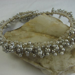 Sophisticated silver and silver-grey pearls paired with facet cut rock crystal beads on silver filled wire and silver-grey satin ribbon