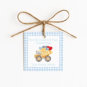 May include: A Valentine's Day gift tag with a blue gingham border and a watercolor illustration of a yellow dump truck carrying heart-shaped balloons. The tag reads "You're loads of fun Valentine!" and "Your friend, Henry."