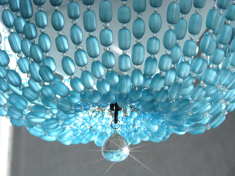May include: A blue glass beaded chandelier with a crystal drop pendant.