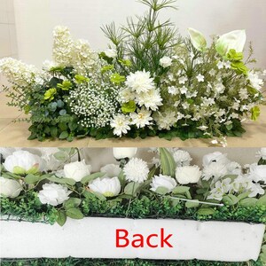 May include: A white artificial flower arrangement with a variety of flowers and greenery. The arrangement is in a white rectangular container with the word "Back" printed on the front.