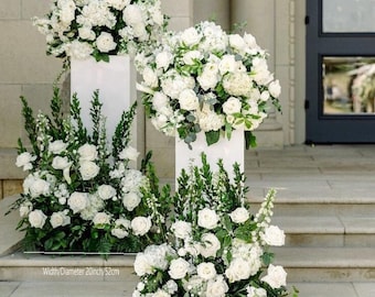May include: White flower arrangements on white pedestals, with the text "Width/Diameter 22 inch/57cm" and "Width/Diameter 20 inch/52cm" on the steps.
