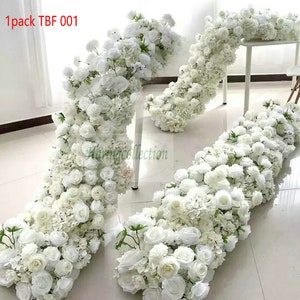 May include: White artificial flower garland, made of roses and hydrangeas, arranged in a cascading design. The garland is displayed on a white table and floor. The text "1pack TBF 001" is visible in the top left corner of the image.