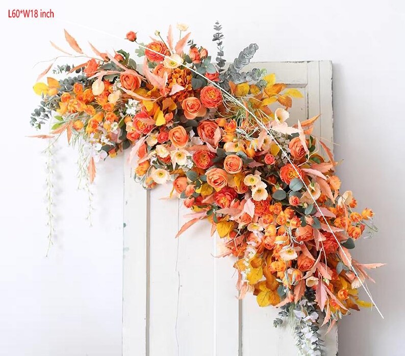 May include: A floral garland with orange and yellow flowers and greenery. The garland is 60 inches long and 18 inches wide.