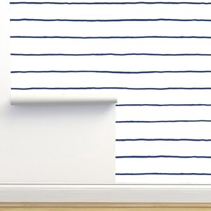May include: A roll of white wallpaper with navy blue horizontal stripes. The wallpaper is partially unrolled, revealing the pattern.