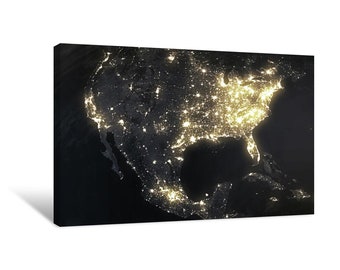 May include: A satellite image of North America at night, showing the bright lights of cities and towns across the continent. The image is taken from space and shows the vastness of the continent and the concentration of human activity in urban areas.