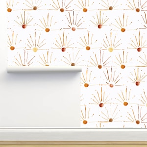 May include: White wallpaper with a repeating pattern of stylized suns in shades of brown, orange, and yellow. The suns have a dotted outline and radiating lines.