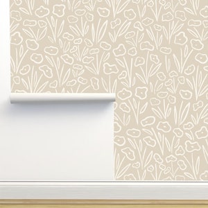 May include: A beige wallpaper with a white floral pattern. The pattern features simple, hand-drawn flowers and leaves.