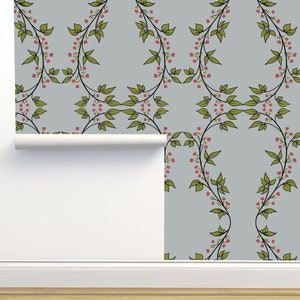 May include: A roll of wallpaper with a repeating pattern of green vines and pink flowers on a light gray background.