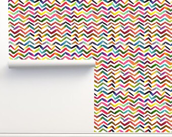 May include: A colorful chevron pattern wallpaper with a white background. The wallpaper is rolled up and partially unrolled, showing the pattern.