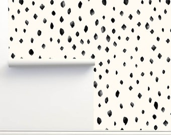 May include: Cream-colored wallpaper with a repeating pattern of irregularly shaped black spots. The wallpaper is partially unrolled, revealing a white backing. The design is reminiscent of a dalmatian's coat.