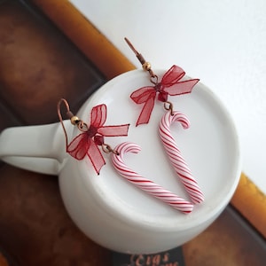 Christmas candy cane earrings, cute candy earrings handmade from polymer clay, peppermint cane earrings decorated with bow, Christmas candy