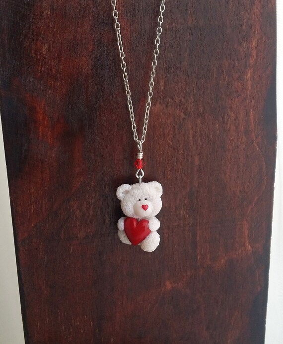 white teddy bear holding a heart