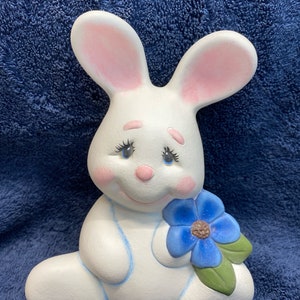Handmade ceramic sitting bunny with flower