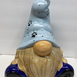 One of a kind handmade ceramic haggard gnome with puppy paw prints cut out.