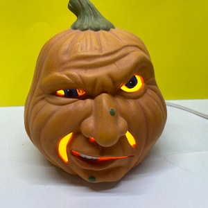 One of a kind ceramic snarly pumpkin with an orange blinking light.