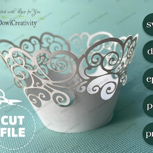 May include: A white cupcake wrapper with a delicate, intricate, swirl design. The wrapper is made for a standard-sized cupcake. The image includes the text "Created with Love for You" and "DowiCreativity".