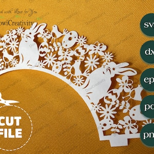 May include: White cupcake wrapper with a cut-out design featuring bunnies, birds, flowers, and eggs. The text "Created with love for you" and "DowiCreativity" is included in the design.
