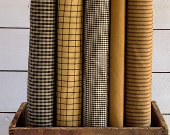 May include: Four rolls of fabric in a wooden crate. The fabric is a brown and tan plaid pattern. The crate is labeled "Crushed Yeast".