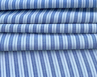 May include: A stack of blue and white striped fabric. The fabric is folded in thirds and has a subtle texture.