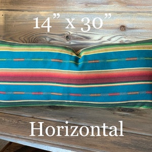 May include: A horizontal striped pillow with a teal, red, orange, yellow, and green color scheme. The pillow measures 14 inches by 30 inches.