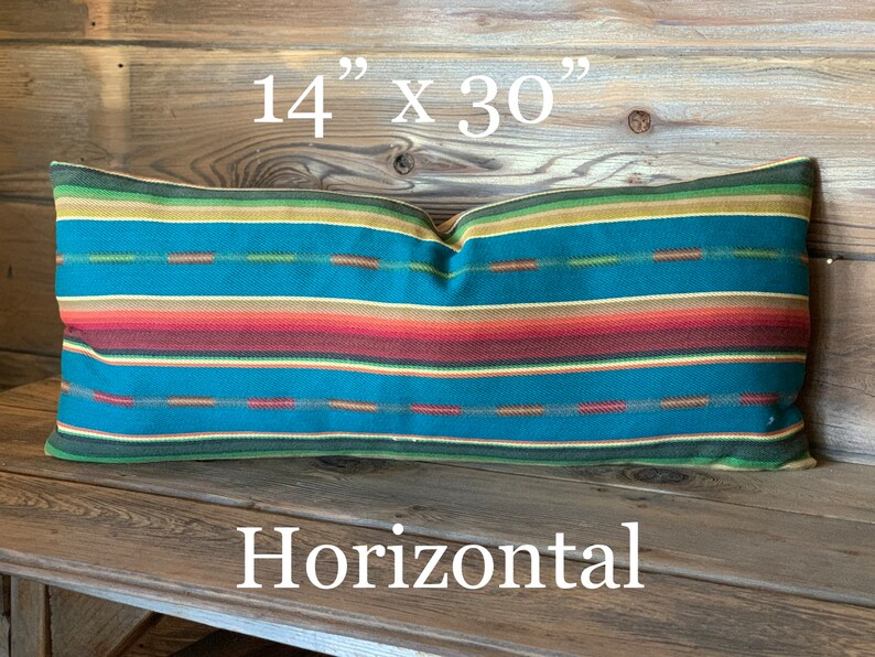 May include: A horizontal striped pillow with a teal, red, orange, yellow, and green color scheme. The pillow measures 14 inches by 30 inches.