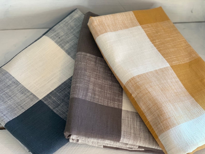 May include: Three fabric swatches with a checkered pattern. The swatches are in black and white, brown and white, and yellow and white.