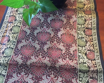 Patterned Brocade Jamavar silk table runner in black and brown woven with floral red and green gold threads. Great for holiday entertainment