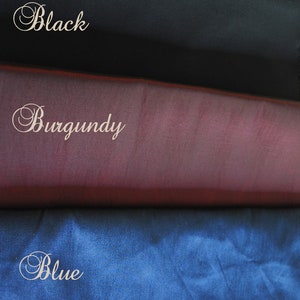 May include: Three fabric swatches in black, burgundy, and blue. The swatches are stacked on top of each other, with the black swatch on top, the burgundy swatch in the middle, and the blue swatch on the bottom.