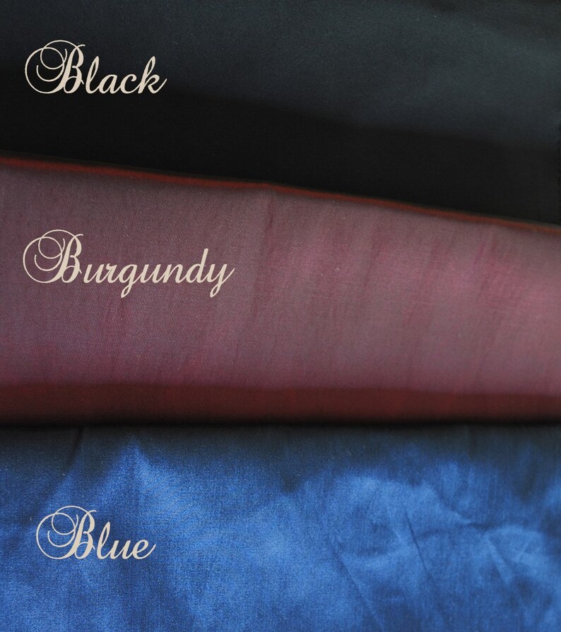 May include: Three fabric swatches in black, burgundy, and blue. The swatches are stacked on top of each other, with the black swatch on top, the burgundy swatch in the middle, and the blue swatch on the bottom.