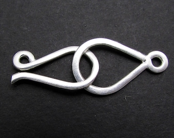 May include: Silver-toned metal clasp with a teardrop-shaped loop and a smaller loop on the side.