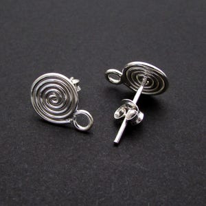May include: A pair of silver earrings with a spiral design. The earrings have a post back closure.