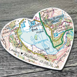 May include: A heart-shaped map with the names Louise and Matthew and the date 12.08.21. The map shows a lake and surrounding area with the names of places like Town End, Grasmere, and Loughrigg Ter.