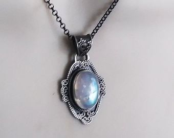 Rainbow moonstone sterling silver pendant in an oval shape
