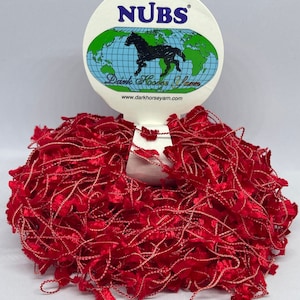 May include: A skein of red yarn with a fuzzy texture. The yarn is labeled "NUBS" and "Dark Horse Yarn" with the website www.darkhorseyarn.com.