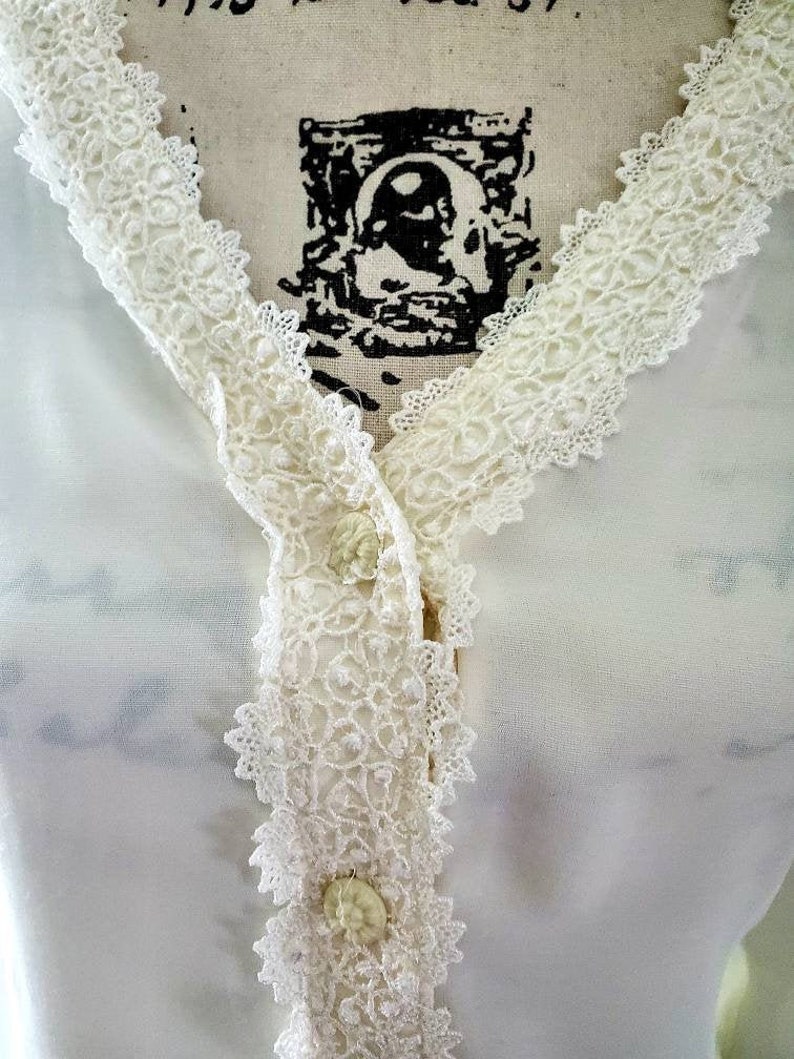 Ivory colored lace trimmed top....front buttons...long sleeves....vintage