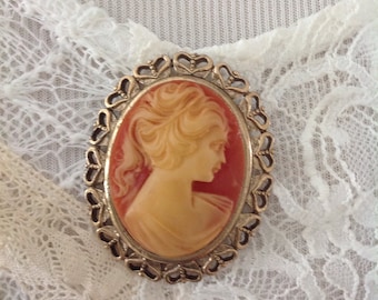 Vintage brooch......lovely maiden.....goldtone.....large....victorian. Antique brass tone filigree frame. Orange and cream cameo. Side view.