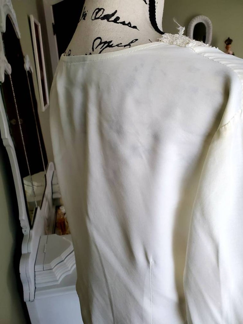 Ivory colored lace trimmed top....front buttons...long sleeves....vintage