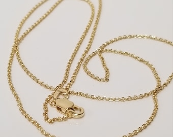 May include: A gold chain necklace with a lobster clasp closure.