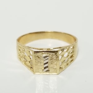 May include: A gold ring with a patterned design and a white gold centre.