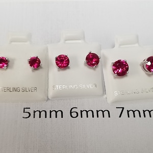 May include: Four pairs of sterling silver stud earrings with round pink gemstones. The earrings are displayed on white cards with the size of each pair listed below: 5mm, 6mm, 7mm, and 8mm.