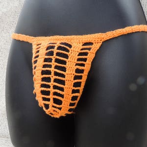 May include: Orange crocheted lingerie with a delicate, open-weave design.