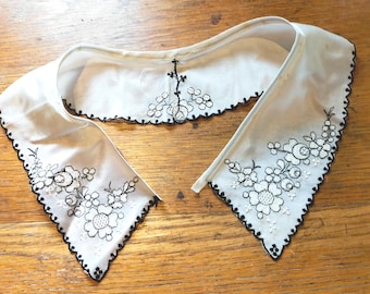 Cream collar with black embroidery. 17" neck X 2 1/4" Came from a museum