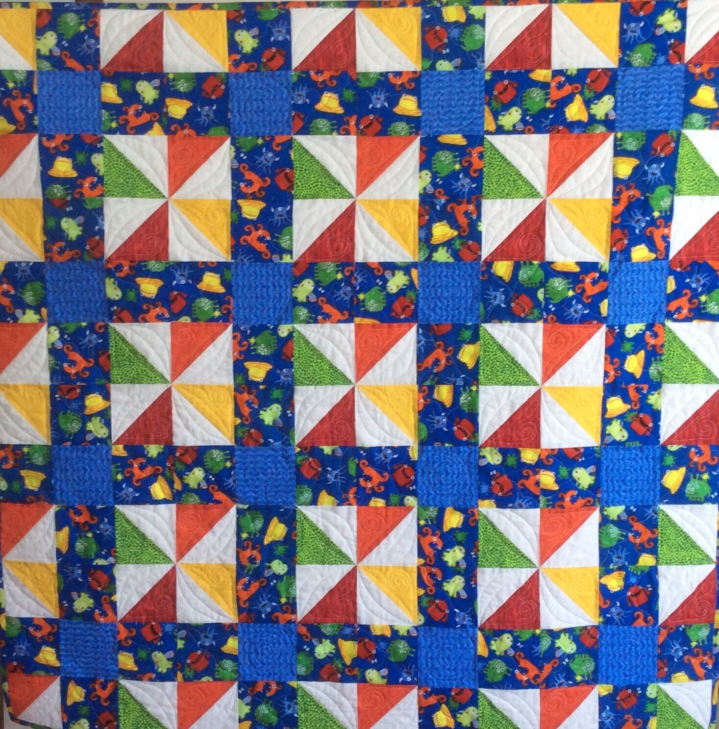 Handmade baby quilt. Calico puzzle monster quilt.