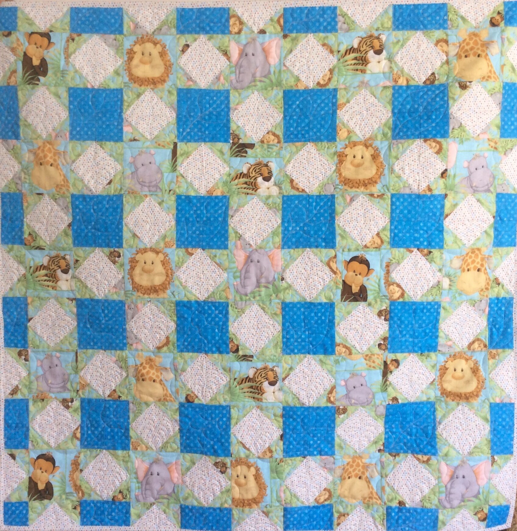 Handmade baby quilt. Jungle babies quilt.