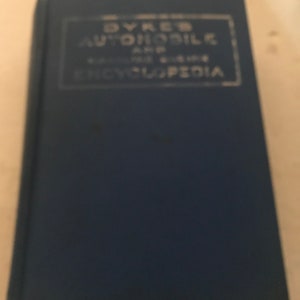 May include: A blue hardcover book with the title "Dyke's Automobile and Gasoline Encyclopedia" printed in white on the front cover.