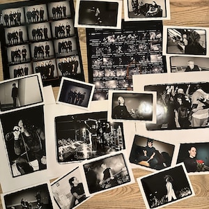 May include: A collection of black and white photographs of a band, including individual portraits, group shots, and live performance images.